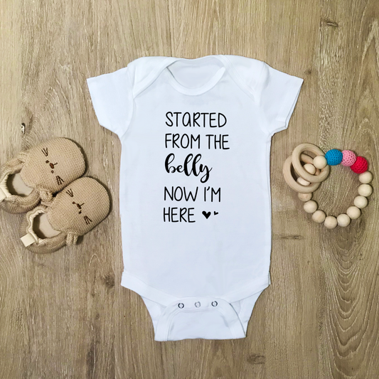 Started From The Belly Now I'm Here - Baby Bodysuit